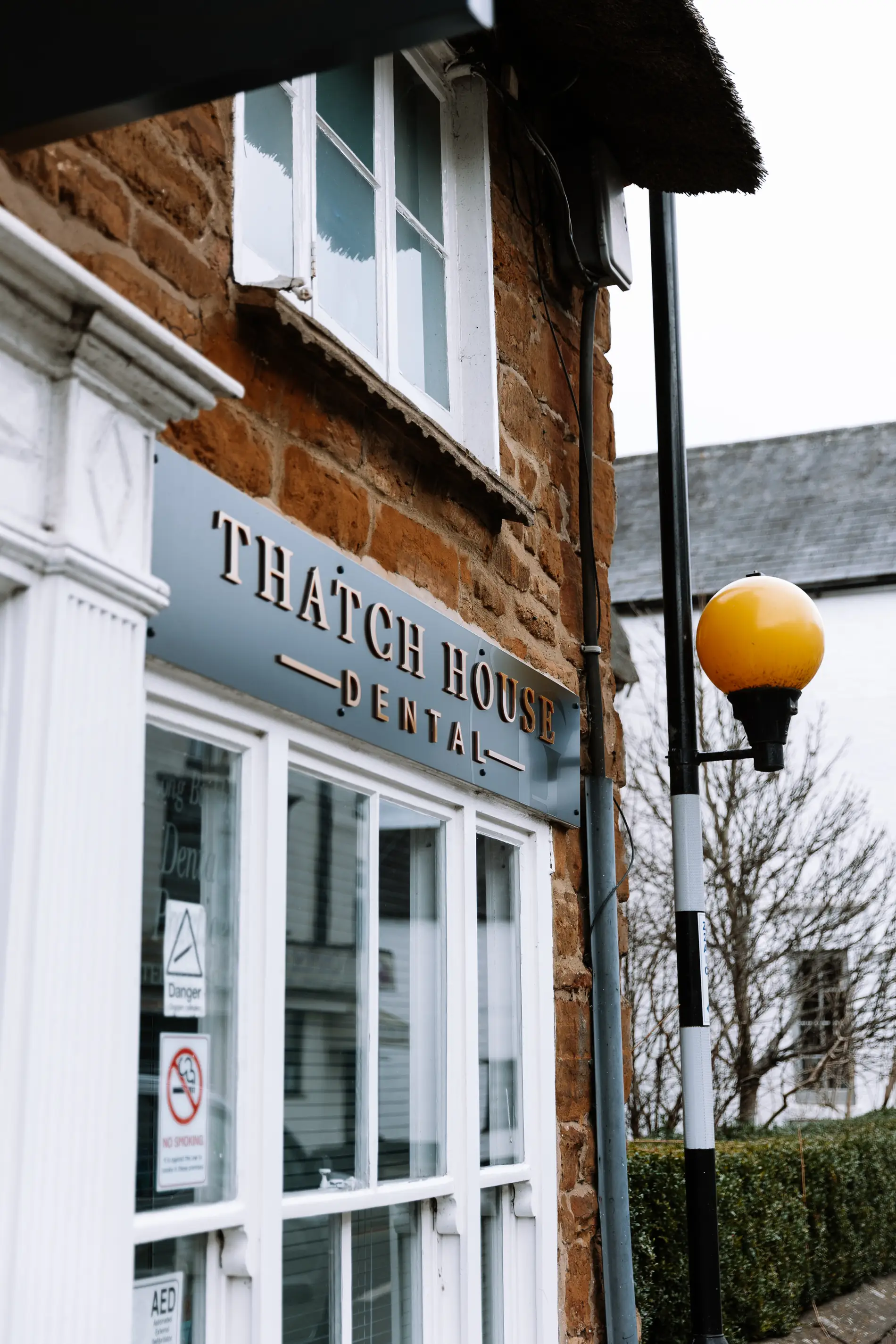 Thatch house dental fascia sign built up gold lettering Mindlabs Media