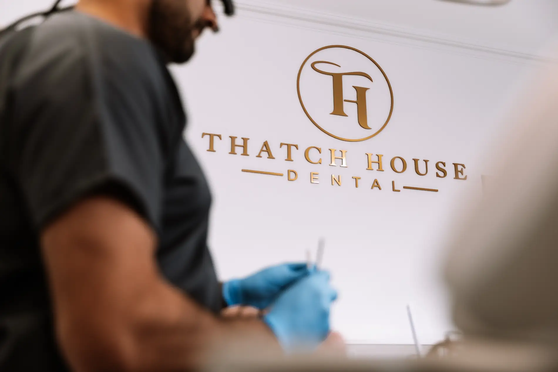 Thatch house dental interior branding gold logo wall reception Mindlabs Media