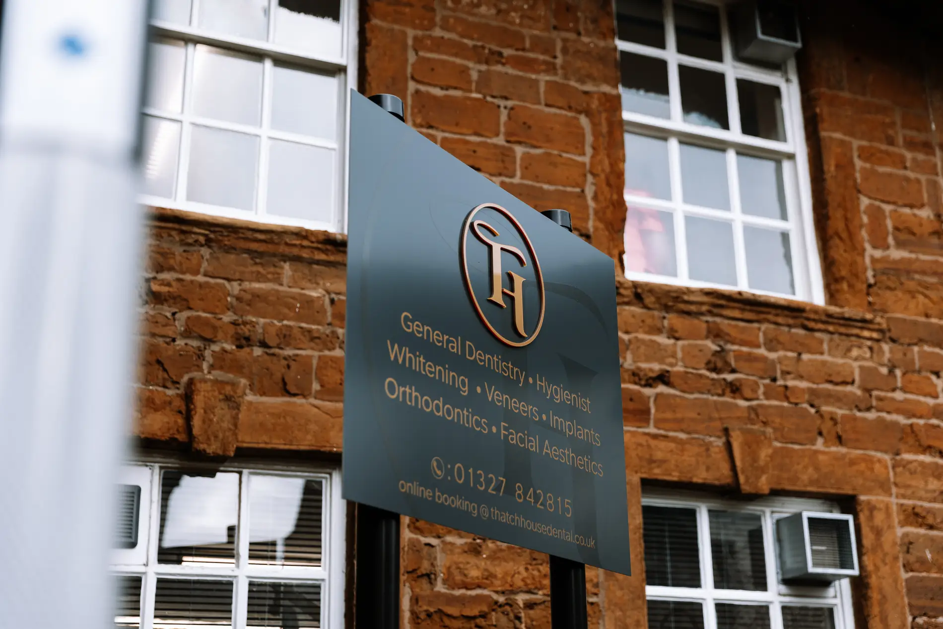 Thatch house dental post mounted sign gold lettering treatment list Mindlabs Media